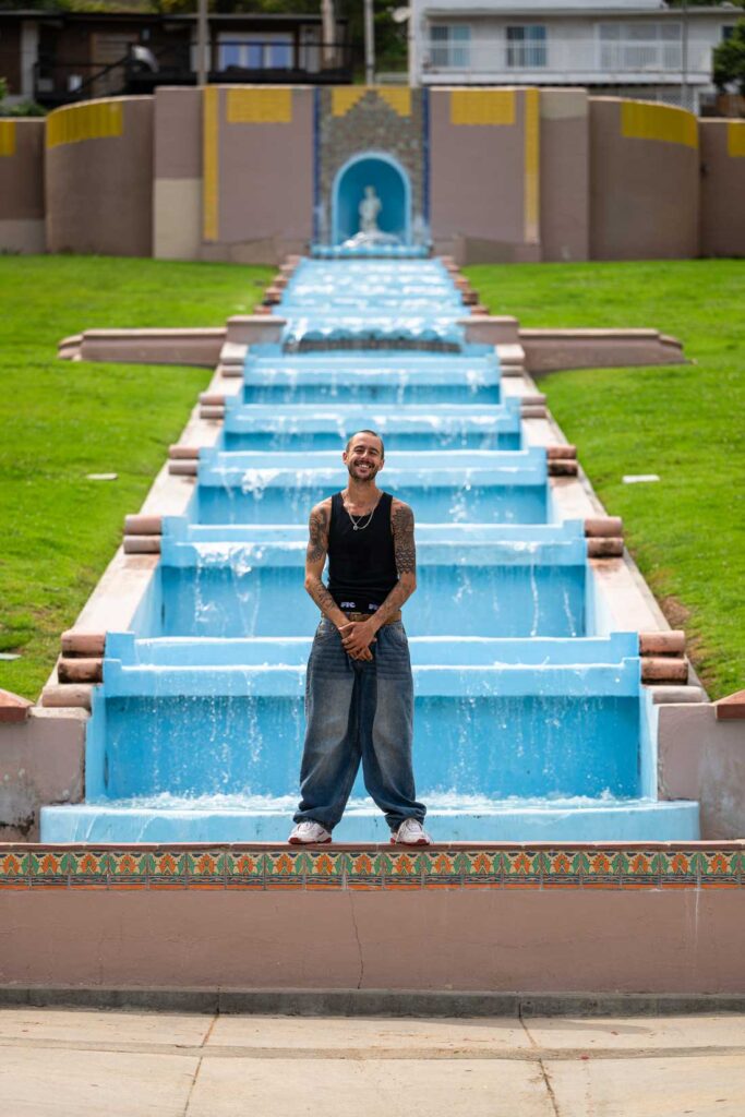 TJ Rogers in front of a fountain